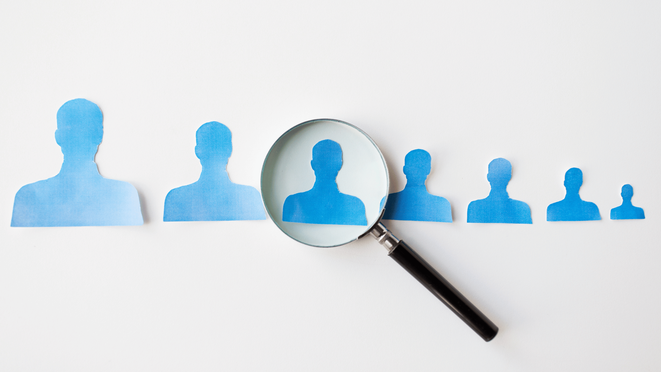 year-end hiring magnifying glass on a person